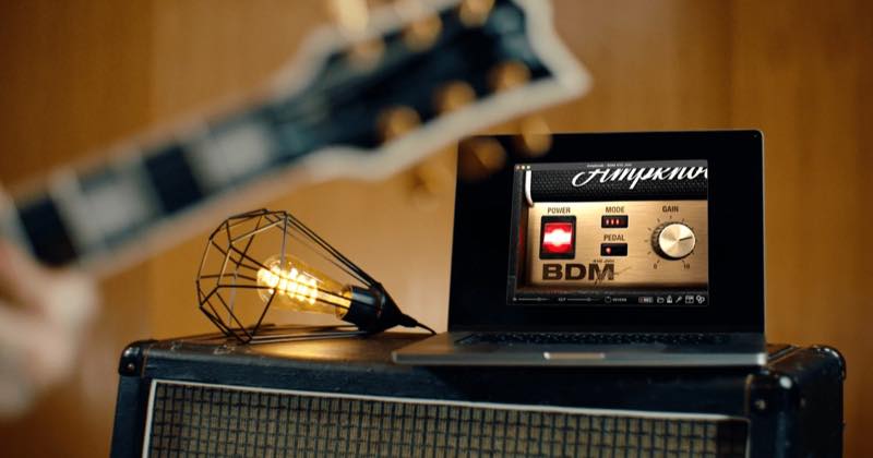 Laptop displaying the Ampknob BDM 410 JVH interface on a guitar amplifier beside a lamp.